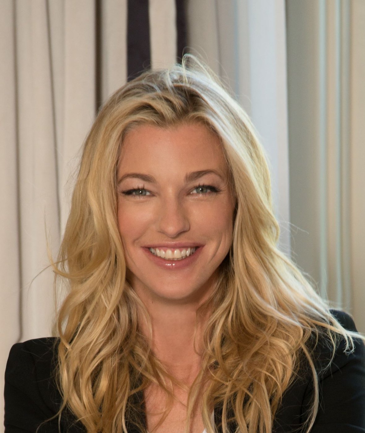 Nicole Junkerman smiling warmly in a sunlit room